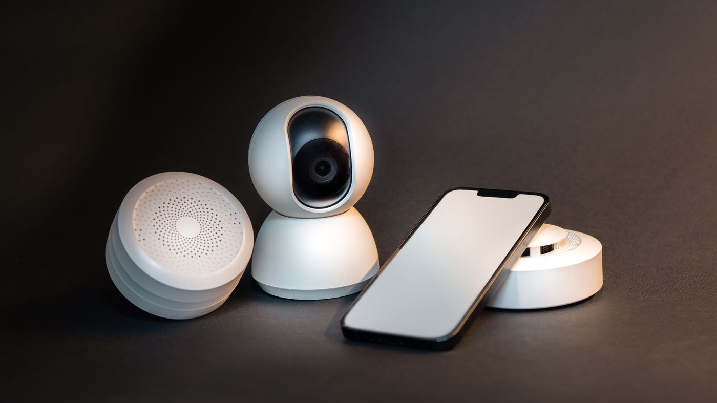 Consumer electronics and smart home devices on a dark surface